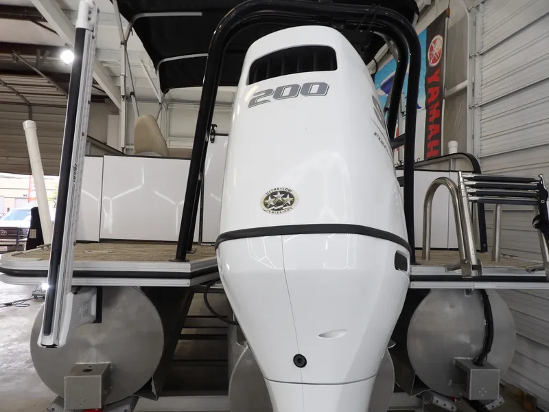 Slide: The Image of A 2022 SilverWave 2410 RLP SW3 with a large outboard motor in a storage facility. - 18