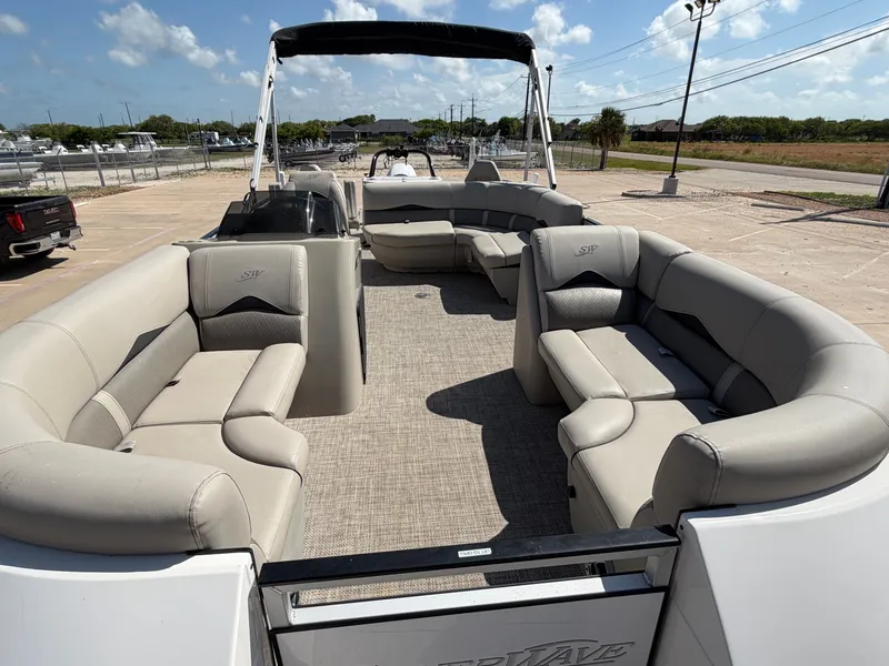 Slide: The Image of The image shows the spacious deck of a SilverWave 2410 RLP SW3 pontoon boat with beige seating. - 29