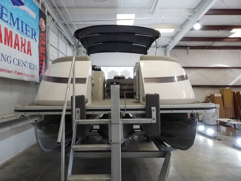 Slide: The Image of A 2022 SilverWave 2410 RLP SW3 pontoon boat is on a trailer in a warehouse. - 12