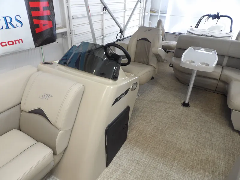 Slide: The Image of Interior of a 2022 SilverWave 2410 RLP SW3 with beige seating and a helm station. - 6