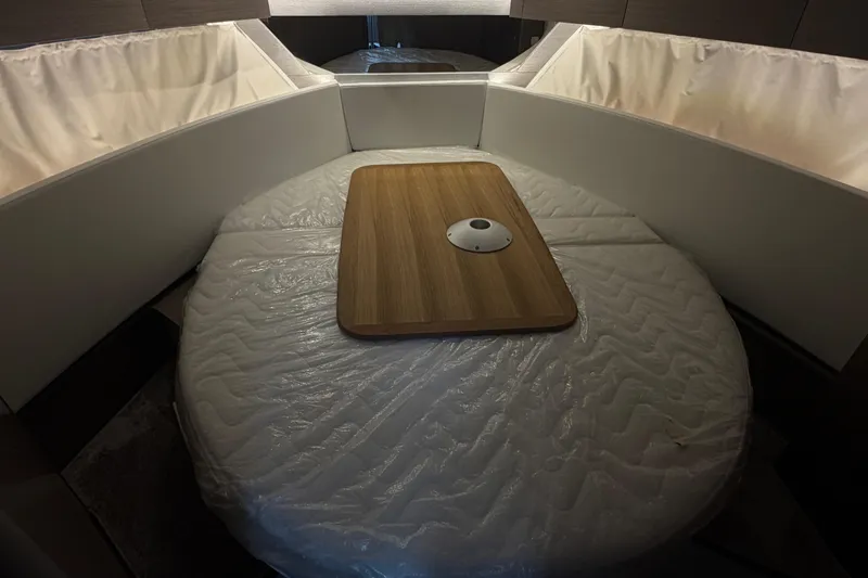 Slide: The Image of Interior cabin of 2026 Jeanneau NC 1095 Coupe with convertible seating and wooden table. - 106