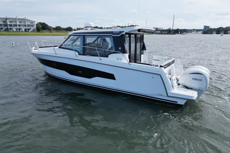 Slide: The Image of 2026 Jeanneau NC 1095 Coupe boat on water with Yamaha engines. - 4