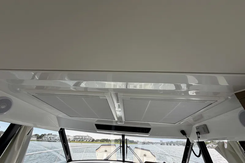 Slide: The Image of Interior view of 2026 Jeanneau NC 1095 Coupe boat, showcasing sleek design and panoramic windows. - 95