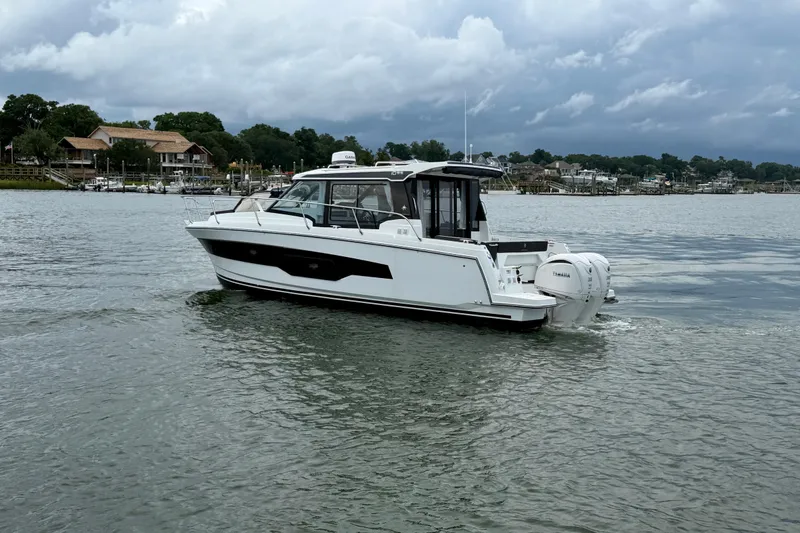 Slide: The Image of 2026 Jeanneau NC 1095 Coupe cruising on a calm lake under cloudy skies. - 66