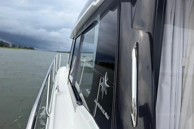 Slide: The Image of 2026 Jeanneau NC 1095 Coupe cruising on a cloudy day, showcasing sleek design and modern features. - 86