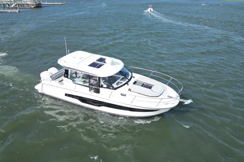 Slide: The Image of 2026 Jeanneau NC 1095 Coupe cruising on open water, showcasing sleek design and modern features. - 8