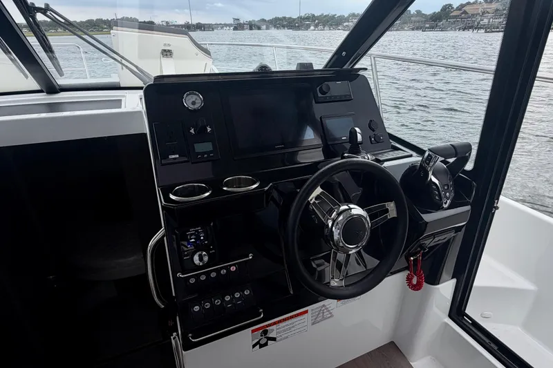 Slide: The Image of Helm of 2026 Jeanneau NC 1095 Coupe with modern controls and steering wheel. - 103