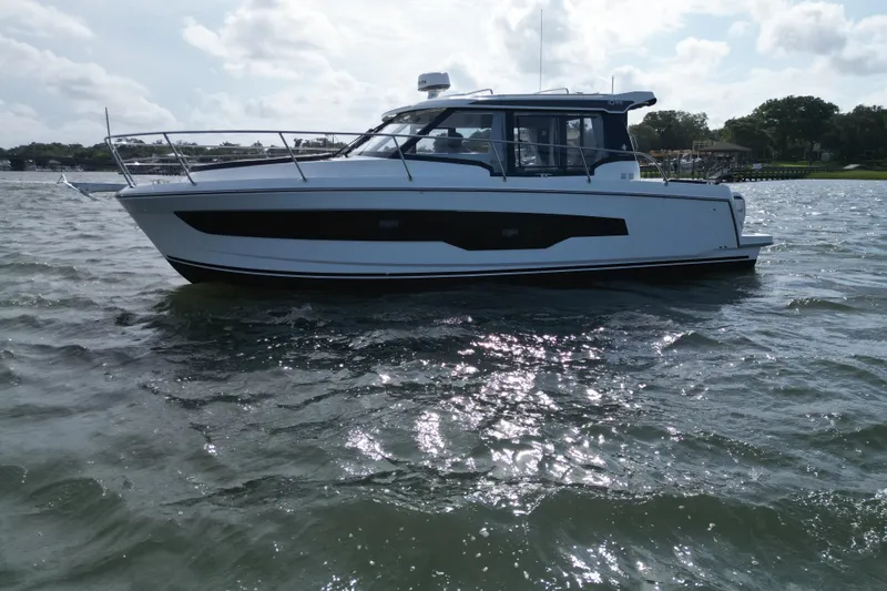 Slide: The Image of 2026 Jeanneau NC 1095 Coupe boat cruising on a sunny day. - 47