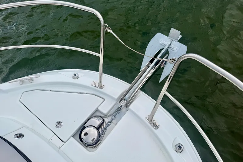Slide: The Image of Bow of 2026 Jeanneau NC 1095 Coupe with anchor and railing over water. - 70