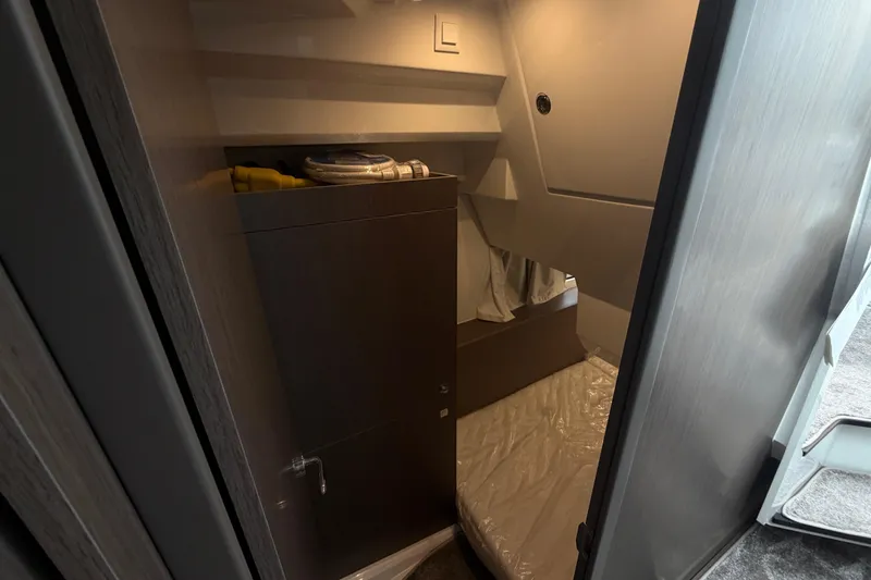 Slide: The Image of 2026 Jeanneau NC 1095 Coupe cabin interior with bed and storage. - 107