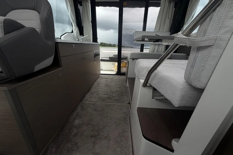 Slide: The Image of Interior of 2026 Jeanneau NC 1095 Coupe, featuring modern seating and cabinetry. - 114