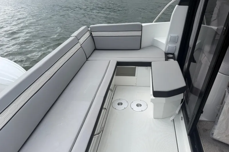 Slide: The Image of 2026 Jeanneau NC 1095 Coupe boat interior with sleek seating and modern design. - 83
