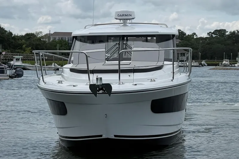 Slide: The Image of 2026 Jeanneau NC 1095 Coupe boat on water, front view with Garmin radar. - 52