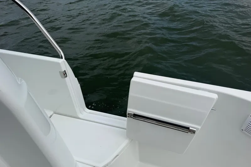 Slide: The Image of 2026 Jeanneau NC 1095 Coupe boat deck with open side door, overlooking water. - 88