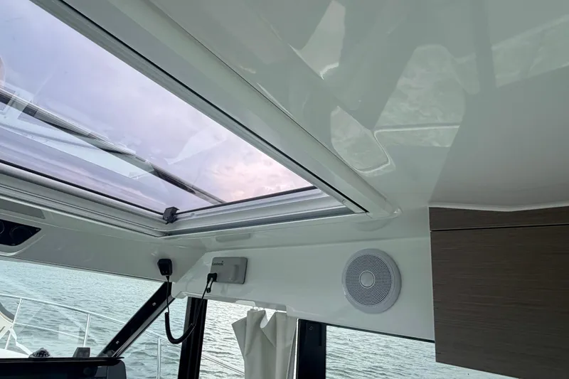 Slide: The Image of Interior view of 2026 Jeanneau NC 1095 Coupe with skylight and speaker. - 100
