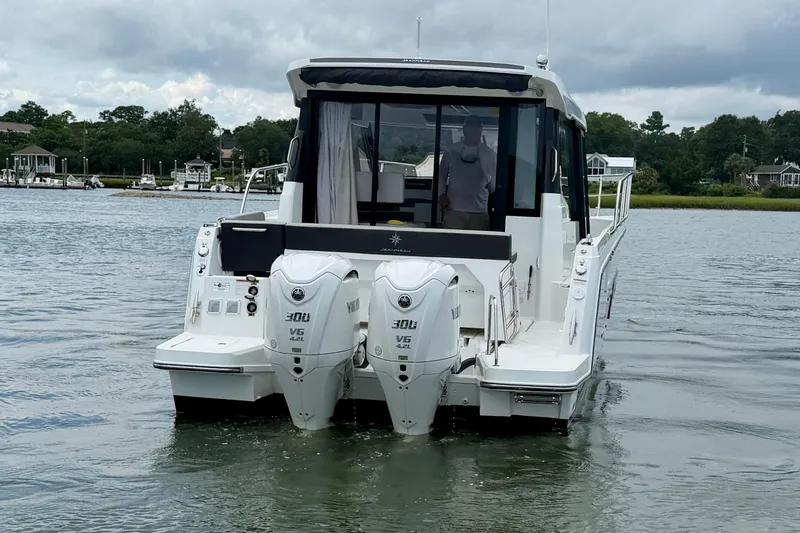 Slide: The Image of 2026 Jeanneau NC 1095 Coupe with dual Yamaha 300 engines on a calm river. - 58