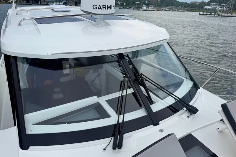 Slide: The Image of 2026 Jeanneau NC 1095 Coupe boat with Garmin equipment on a calm waterway. - 74