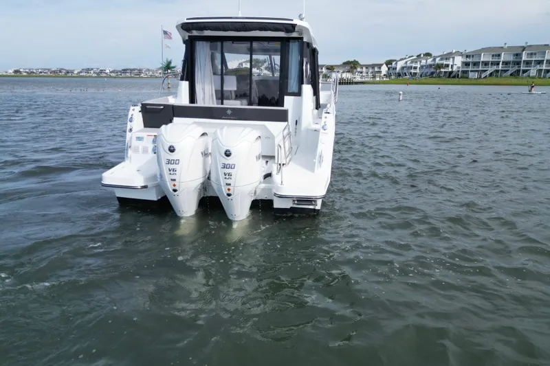 Slide: The Image of 2026 Jeanneau NC 1095 Coupe with dual 300 V6 engines on water. - 7
