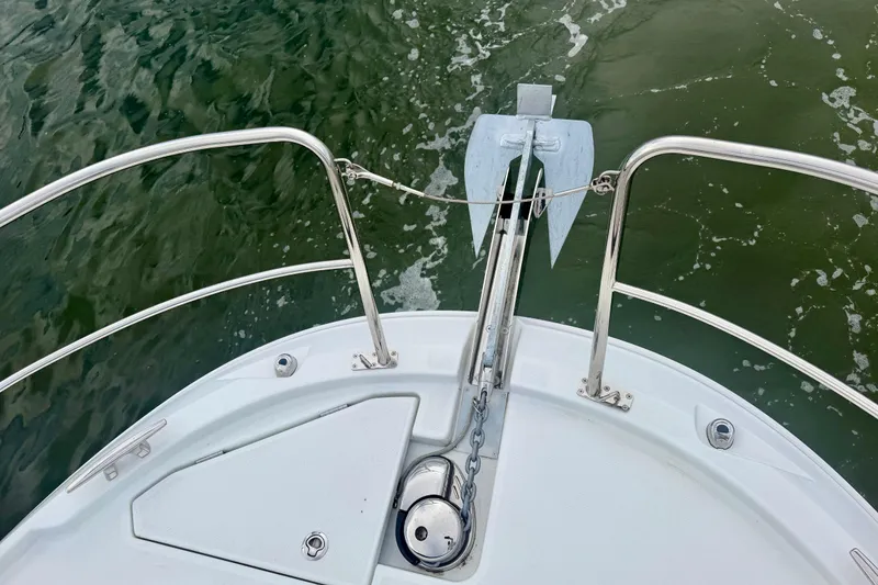 Slide: The Image of Bow view of 2026 Jeanneau NC 1095 Coupe with anchor and railing over water. - 71