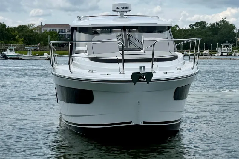 Slide: The Image of 2026 Jeanneau NC 1095 Coupe boat on water, front view with Garmin equipment. - 53