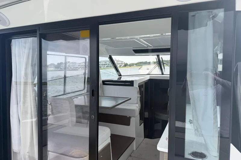 Slide: The Image of Interior view of 2026 Jeanneau NC 1095 Coupe boat with sliding glass doors. - 89