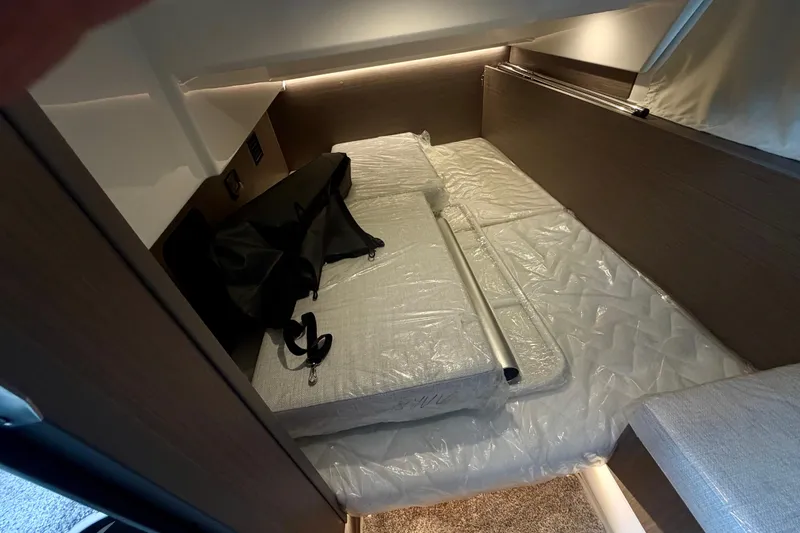 Slide: The Image of Interior cabin of 2026 Jeanneau NC 1095 Coupe with bed and storage space. - 112