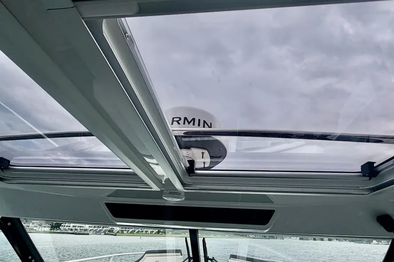 Slide: The Image of 2026 Jeanneau NC 1095 Coupe with Garmin radar, viewed through panoramic sunroof. - 102