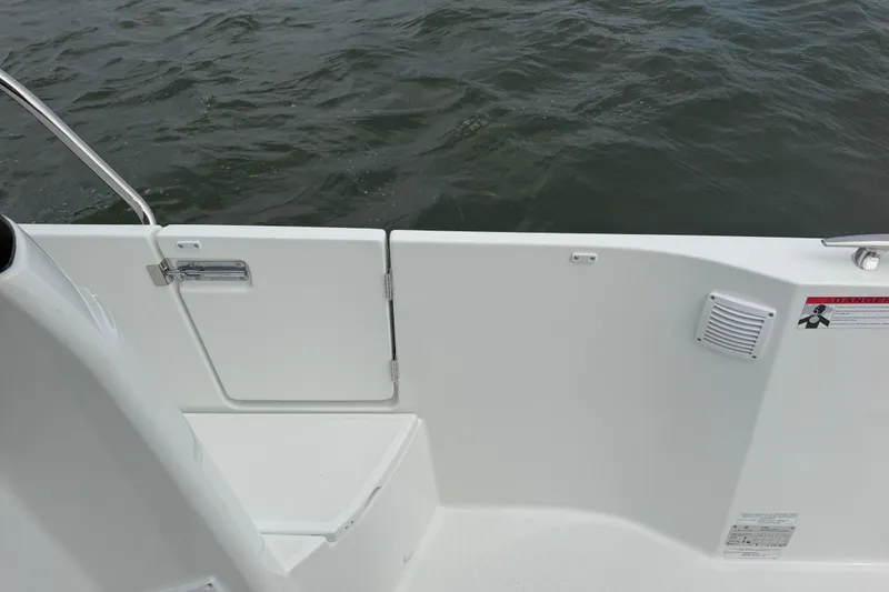 Slide: The Image of 2026 Jeanneau NC 1095 Coupe boat deck with safety features and water view. - 81
