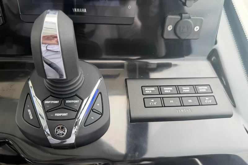 Slide: The Image of Joystick and control panel of 2026 Jeanneau NC 1095 Coupe boat, featuring Yamaha controls. - 76