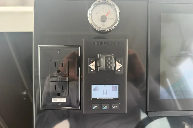 Slide: The Image of Control panel of 2026 Jeanneau NC 1095 Coupe with power outlet and gauge. - 80