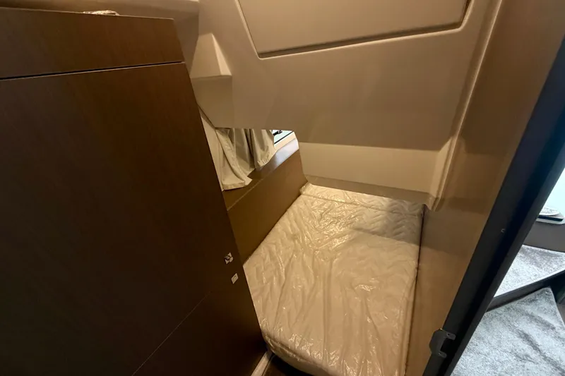 Slide: The Image of Interior cabin of 2026 Jeanneau NC 1095 Coupe with cozy bed and wooden accents. - 108