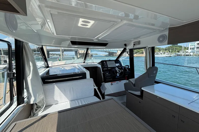 Slide: The Image of Interior view of 2026 Jeanneau NC 1095 Coupe Series 2 boat, featuring helm and seating area. - 9