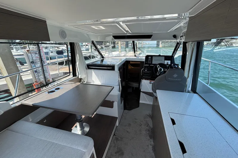 Slide: The Image of Interior of 2026 Jeanneau NC 1095 Coupe Series 2, featuring helm and dining area. - 6