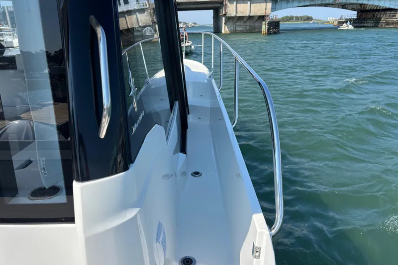 Slide: The Image of 2026 Jeanneau NC 1095 Coupe Series 2 boat on water near a bridge. - 32