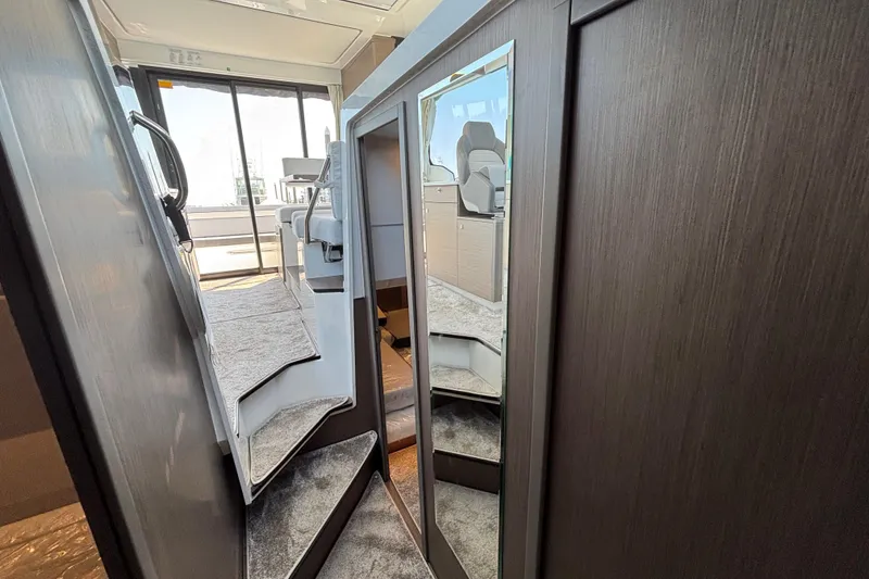 Slide: The Image of Interior of 2026 Jeanneau NC 1095 Coupe Series 2, featuring modern staircase and sleek design. - 22
