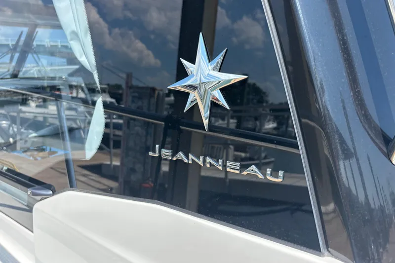 Slide: The Image of Jeanneau NC 1095 Coupe Series 2, 2026 model, with star emblem and reflective glass. - 36