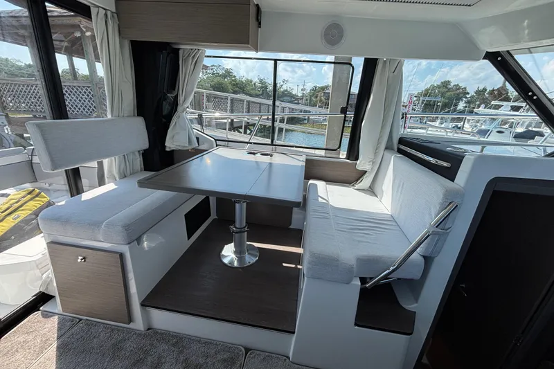 Slide: The Image of Interior of 2026 Jeanneau NC 1095 Coupe Series 2, featuring a modern dining area. - 14