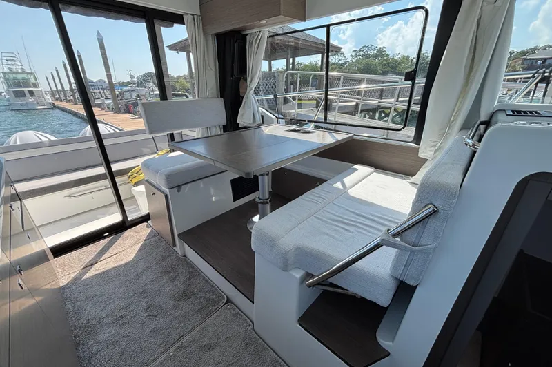 Slide: The Image of Interior of 2026 Jeanneau NC 1095 Coupe Series 2, featuring a modern dining area. - 13