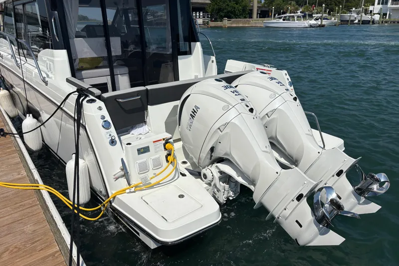 Slide: The Image of 2026 Jeanneau NC 1095 Coupe Series 2 with dual Yamaha outboard engines docked. - 4