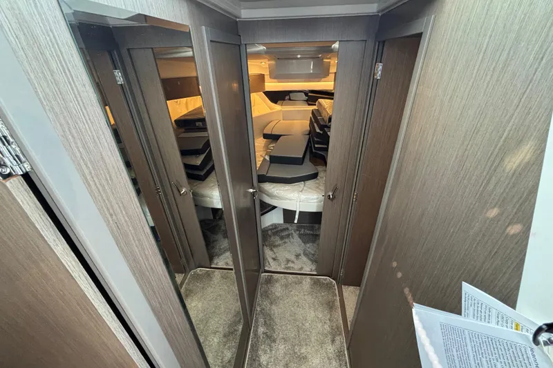 Slide: The Image of Interior view of 2026 Jeanneau NC 1095 Coupe Series 2 cabin with modern wood finish. - 16