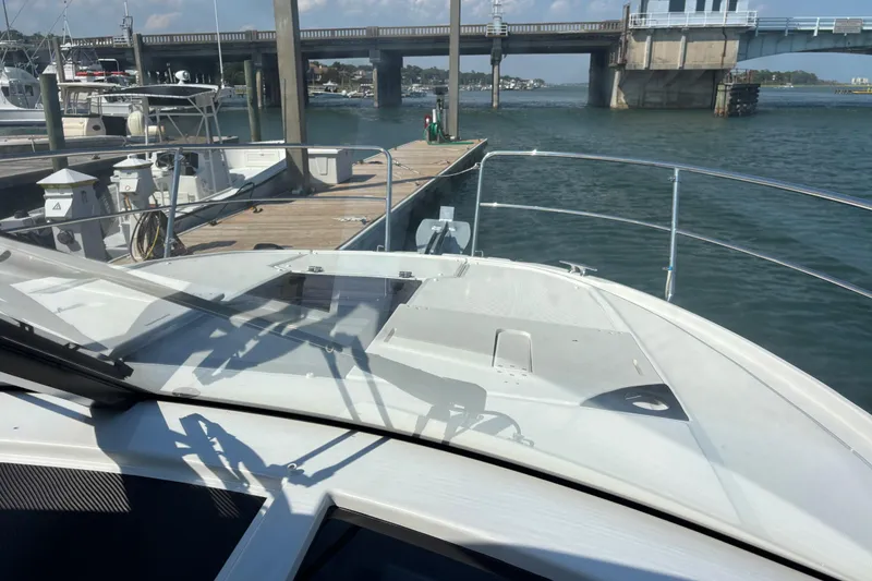 Slide: The Image of 2026 Jeanneau NC 1095 Coupe Series 2 docked near a bridge on a sunny day. - 31