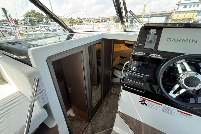Slide: The Image of Interior view of 2026 Jeanneau NC 1095 Coupe Series 2 boat cockpit with Garmin navigation. - 15