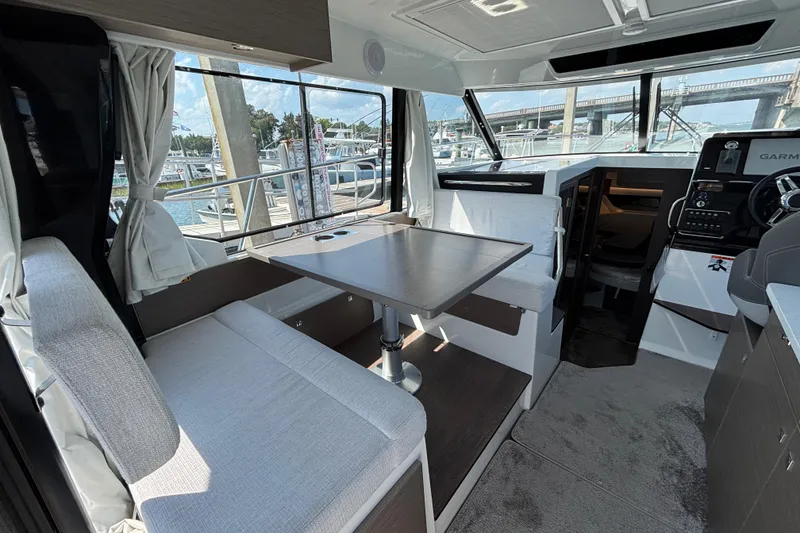 Slide: The Image of Interior of 2026 Jeanneau NC 1095 Coupe Series 2, featuring dining area and helm. - 7