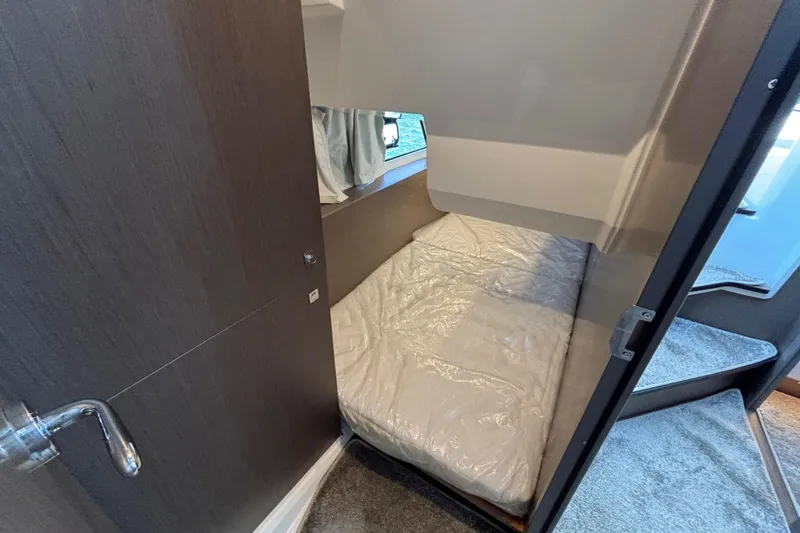 Slide: The Image of Interior cabin of 2026 Jeanneau NC 1095 Coupe Series 2 with cozy bed and window. - 21