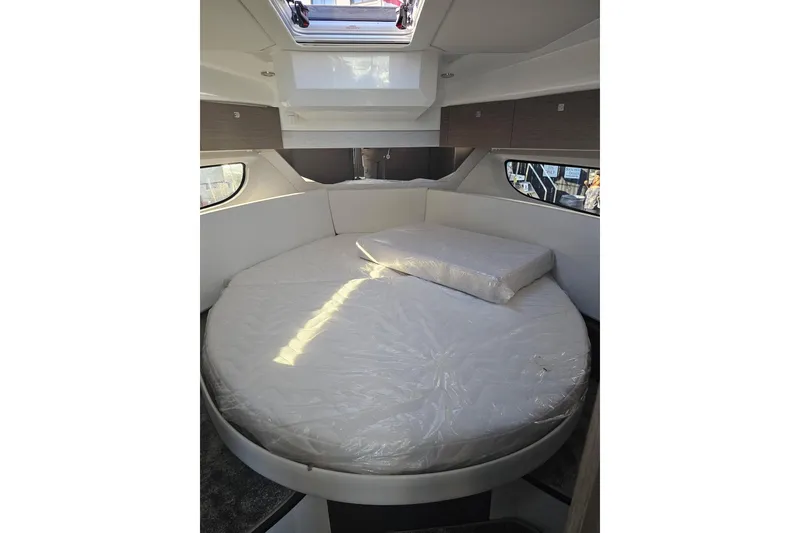 Slide: The Image of Interior cabin of 2026 Jeanneau NC 1095 Coupe Series 2 with round bed and skylight. - 6