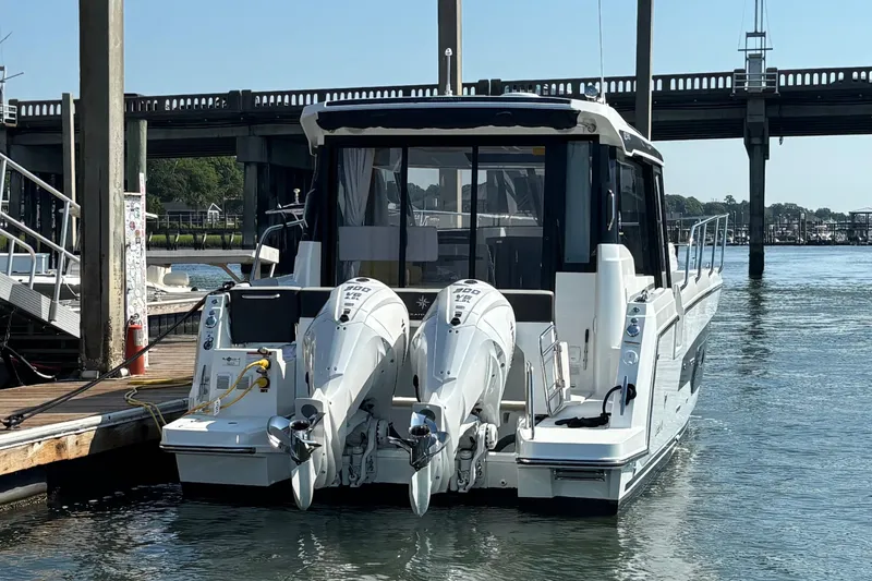 Slide: The Image of 2026 Jeanneau NC 1095 Coupe Series 2 docked with twin outboard engines. - 3