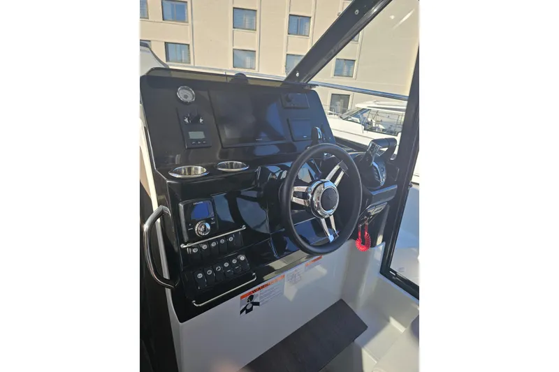 Slide: The Image of Steering console of 2026 Jeanneau NC 1095 Coupe Series 2 boat, featuring modern controls. - 5
