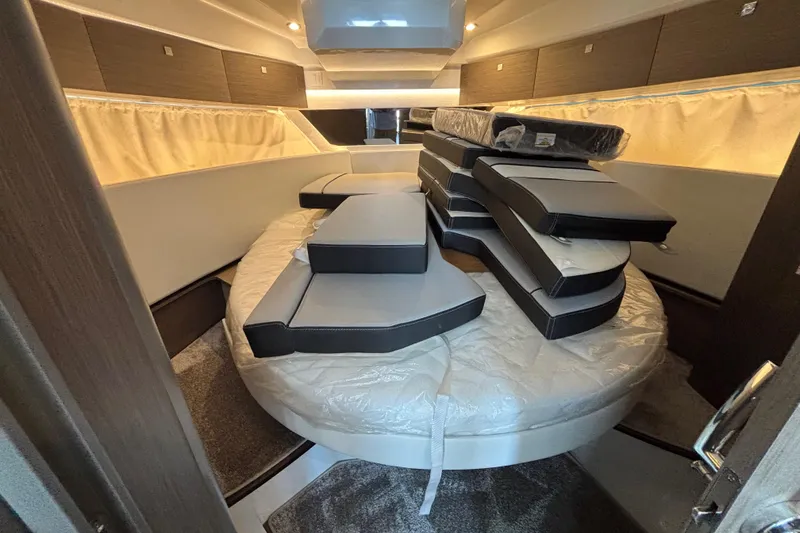 Slide: The Image of Interior cabin of 2026 Jeanneau NC 1095 Coupe Series 2 with stacked cushions. - 18