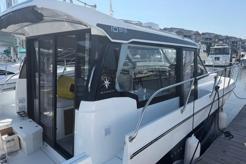 Slide: The Image of 2026 Jeanneau NC 1095 Coupe Series 2 docked at marina, showcasing sleek design. - 1