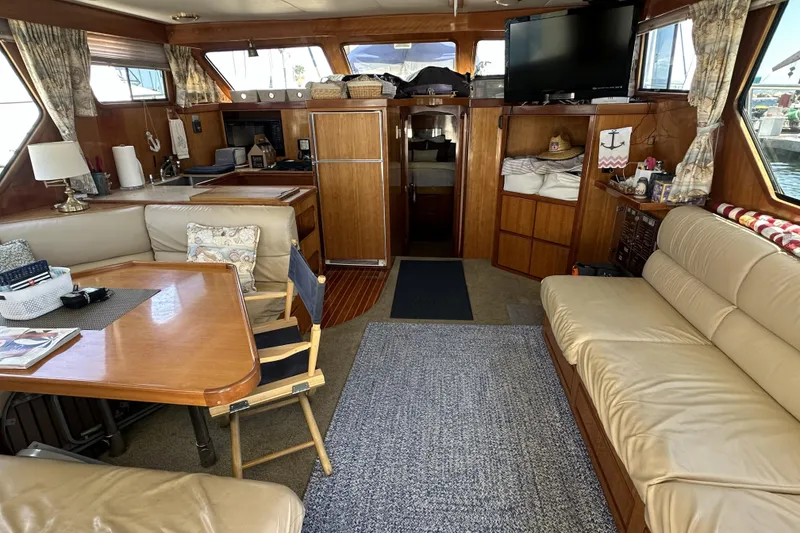 Slide: The Image of Interior of a 1998 Mikelson 43 Sportfisher yacht with cozy seating and wooden finishes. - 11